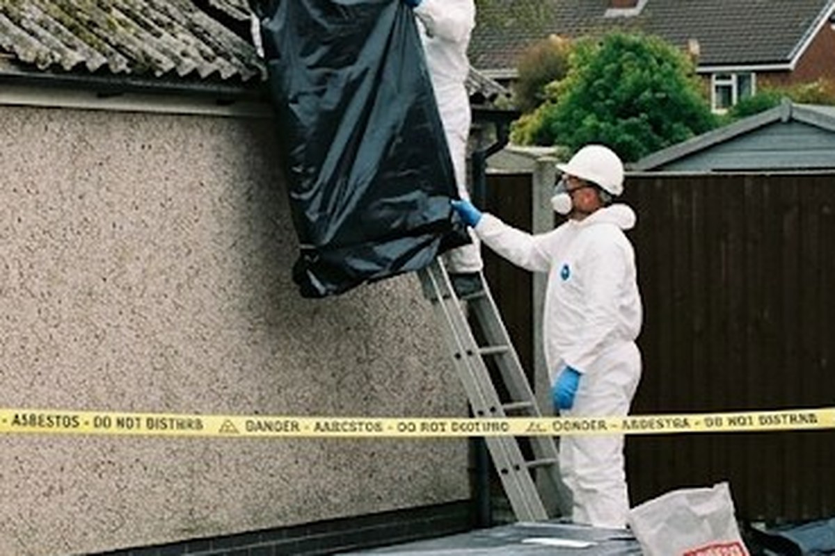 Operative on a ladder at the roof edge